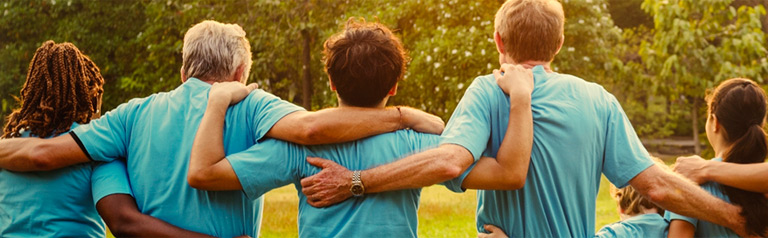 Group of people embracing one another